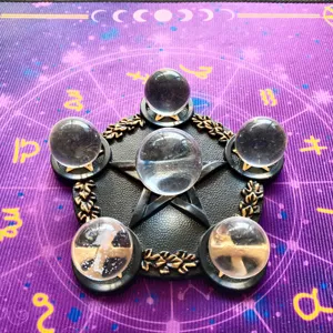 Close-up view of a black resin pentagram stand holding five clear crystal spheres on mat.