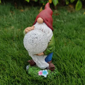 Detailed view of the solar garden gnome resin statue holding a cracked glass ball light.