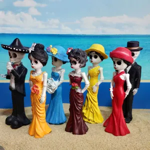 Detailed shot of Halloween skeleton couple figurines standing on sand, festival decor.