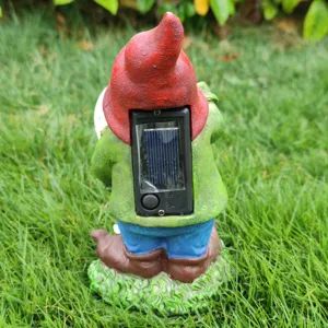 Solar garden gnome figurine detail view, resin outdoor ornament with solar panel and switch.