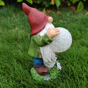 Solar garden gnome resin statue with cracked glass ball light for outdoor yard decor.