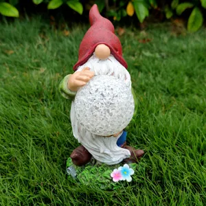 Solar garden gnome statue with cracked glass ball light, resin outdoor yard decor.