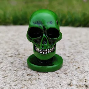 Green skull figurine prop, detailed resin skull model for Halloween decor and sand tray games.