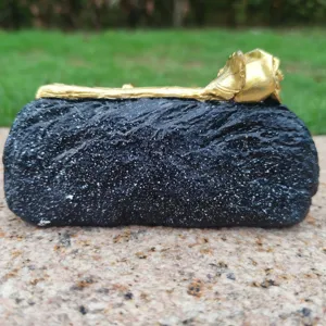Detailed view of black and gold grave memorial rose ornament, decorative resin piece