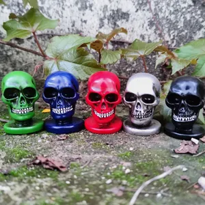Detailed view of colorful miniature skull figurines set, perfect for Halloween props and decor.