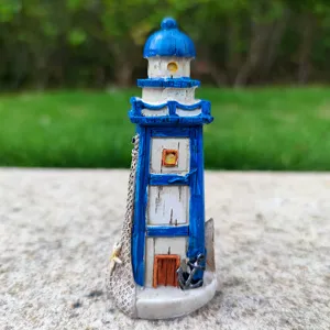 Close-up of Mediterranean style lighthouse resin figurine, detailed fish tank aquarium decor.