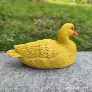Resin yellow duck figurine detail, cute desktop ornament, garden sculpture for home decor.