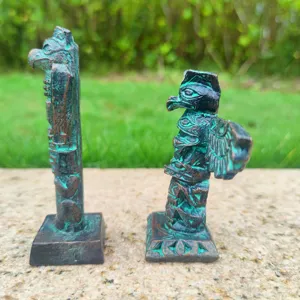 Detail view of resin totem pole miniature sandbox toys and unique collectible figures.