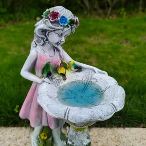 Resin fairy garden statue detail, solar powered angel yard art ornament with bird bath design.