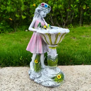 Detailed close-up view of resin fairy bird bath garden statue, outdoor lawn decor ornament.