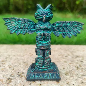 Close-up detail of the resin totem pole sculpture ornament with Alaska engraving, rustic finish.