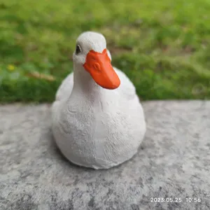 Resin white duck figurine detail view, cute animal sculpture for desktop garden decor.
