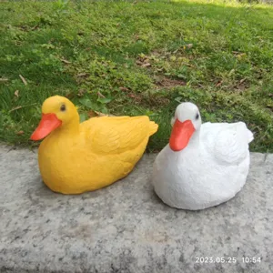 Cute resin duck ornament set, yellow and white animal sculpture for home garden and desktop.