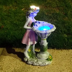 Resin fairy solar garden light detail view, glowing LED birdbath ornament for outdoor yard.