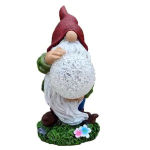 Solar garden gnome resin figurine with cracked glass ball light for outdoor yard decoration.