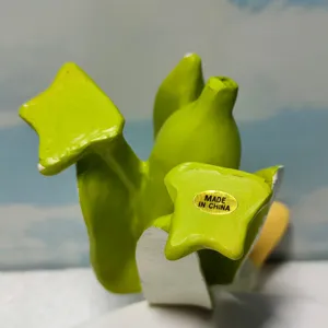 Closeup view of the funny green banana duck figurine detail, showing creative design.