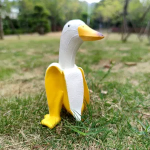 Creative banana duck figurine, cute resin cartoon animal sculpture for home desktop and gift.