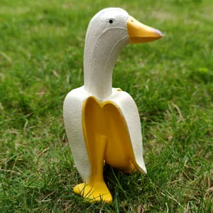 Creative resin banana duck sculpture detail shot, funny animal figurine for garden and desktop decor.