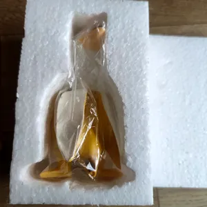 Detail view of the creative banana duck figurine inside protective styrofoam packaging.