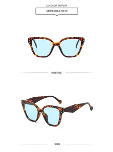 Elegantes gafas de sol geométricas retro de ojo de gato con tachuelas metálicas azules.