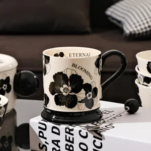 Vintage black and white floral ceramic coffee mug with black handle for home office daily use.