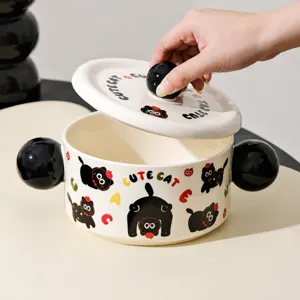 Ceramic dual-handle soup bowl detail showing cute black cat pattern and spherical knob design