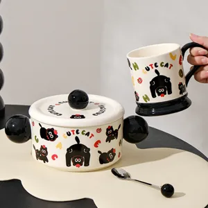Detailed view of the ceramic double-eared bowl and mug set featuring cute black cat patterns.