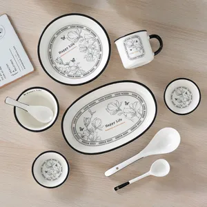 Ceramic tableware set featuring plates bowls cups and spoons with elegant floral design and rim.