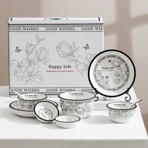 Elegant black and white ceramic tableware set with gift box, floral pattern bowls and plates.