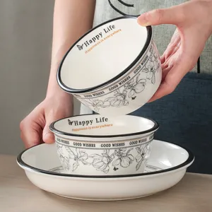 Ceramic tableware set with bowls and plate, elegant black rim design for home daily use.
