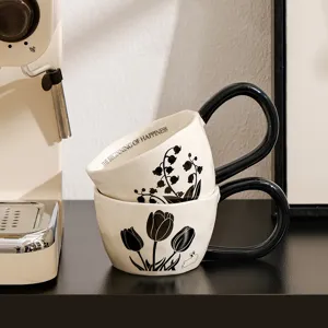 Detail view of vintage ceramic coffee mug with big handle, tulip print, cozy home drinkware.