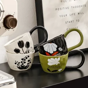 Detailed view of vintage ceramic coffee mugs with unique big ear handle and floral print.