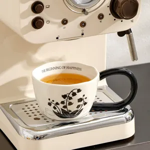 Retro ceramic coffee mug with black handle, vintage floral design for breakfast and coffee.