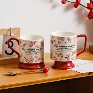 Retro ceramic coffee mug set with red base and floral pattern, elegant gift design detail.