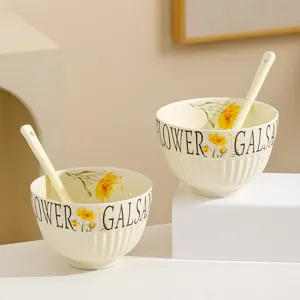 Ceramic rice bowl detail view, cream style floral pattern with spoon for kitchen dining.