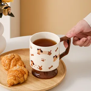 Close-up of a creative ceramic high-foot mug with cute cartoon dachshund pattern and handle.