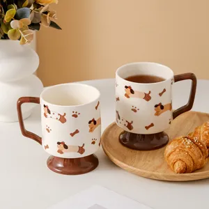 Charming ceramic coffee mug featuring high brown base handle and cute cartoon puppy pattern detail.