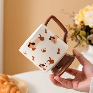 Detailed close-up of creative ceramic coffee mug featuring footed base and cute dog pattern.