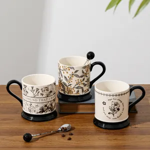 Detailed view of retro ceramic coffee mug with floral pattern, black handle and base.