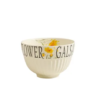Cream ceramic rice bowl with yellow floral print, cute dessert bowl for home table setting.