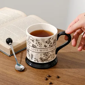 Vintage ceramic coffee mug with retro floral pattern and black handle for office and home use.