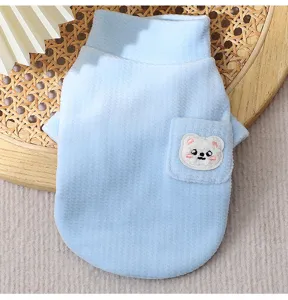 Detail view of the soft blue vertical striped fleece pet vest with cute bear pocket design.