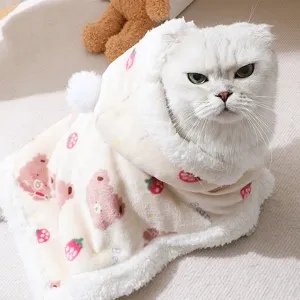 Cute pet winter cloak detail with soft plush fabric, strawberry bear print and cozy hood.