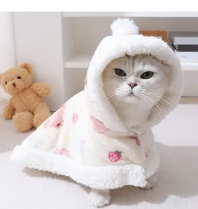 Cute fluffy pet cape detail view, warm winter fleece cloak with lovely strawberry pattern.