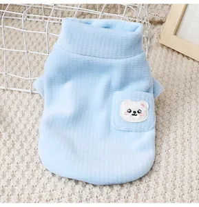 Detailed view of sky blue fleece pet vest with cute bear embroidery pocket and warm collar.