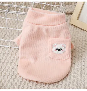 Close-up view of the cute pink pet fleece vest detail featuring a high collar and bear pocket.