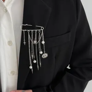 Close-up view of silver safety pin brooch with chains, pearls and charms for men suit.