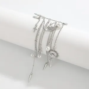 Detailed close-up of men hip-hop tassel rivet brooch, silver metal chain suit pin jewelry.
