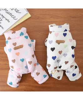 Detailed shot of pet winter warm four-leg clothes with colorful heart print and leather tag.
