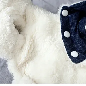 Detail shot of pet winter warm fleece and denim spliced coat with snap buttons for small dogs.